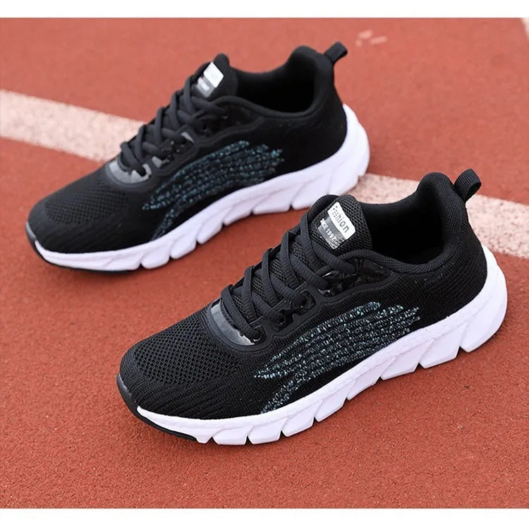 Low-top black and white running sneakers with cross strap design and MD sole