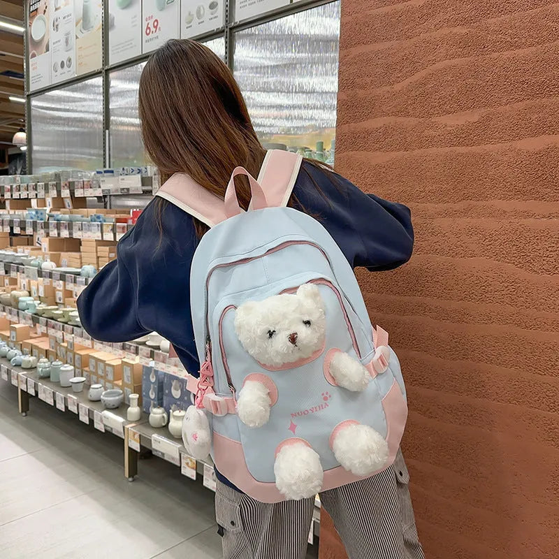 Yellow pink nylon backpack with bear design and curved shoulder straps, 20-35L capacity.