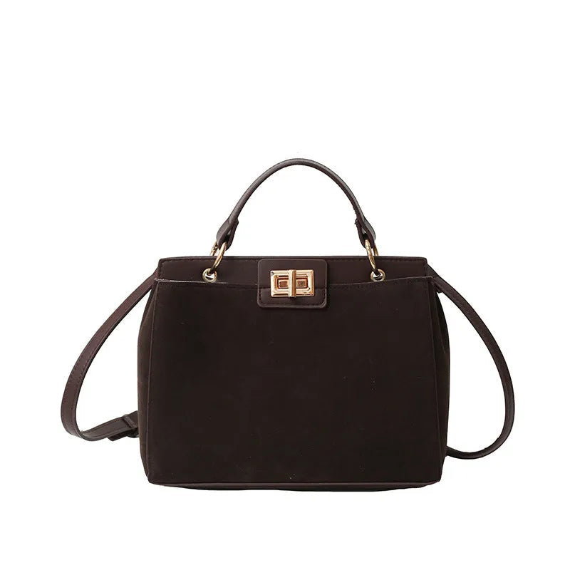 Retro western style messenger bag in black stone pattern with shoulder strap and square vertical shape