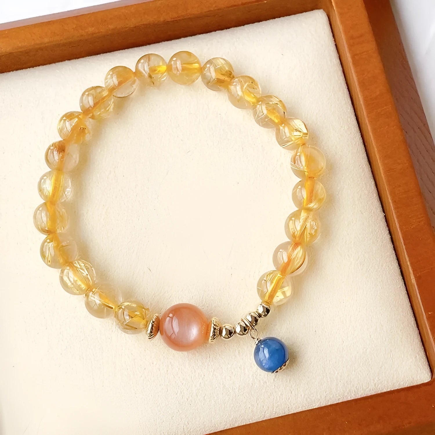 Gold rutilated quartz sunstone bracelet with round beads and diamond-shaped elements
