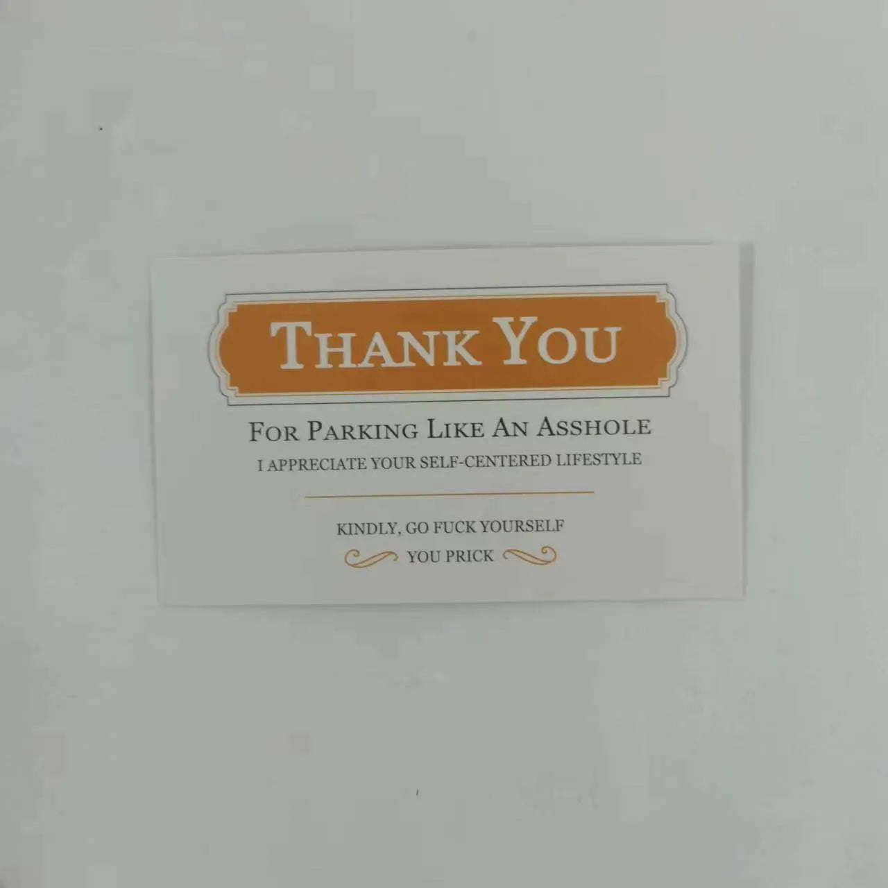 Illegal parking reminder card with middle finger design for vehicle windscreen placement