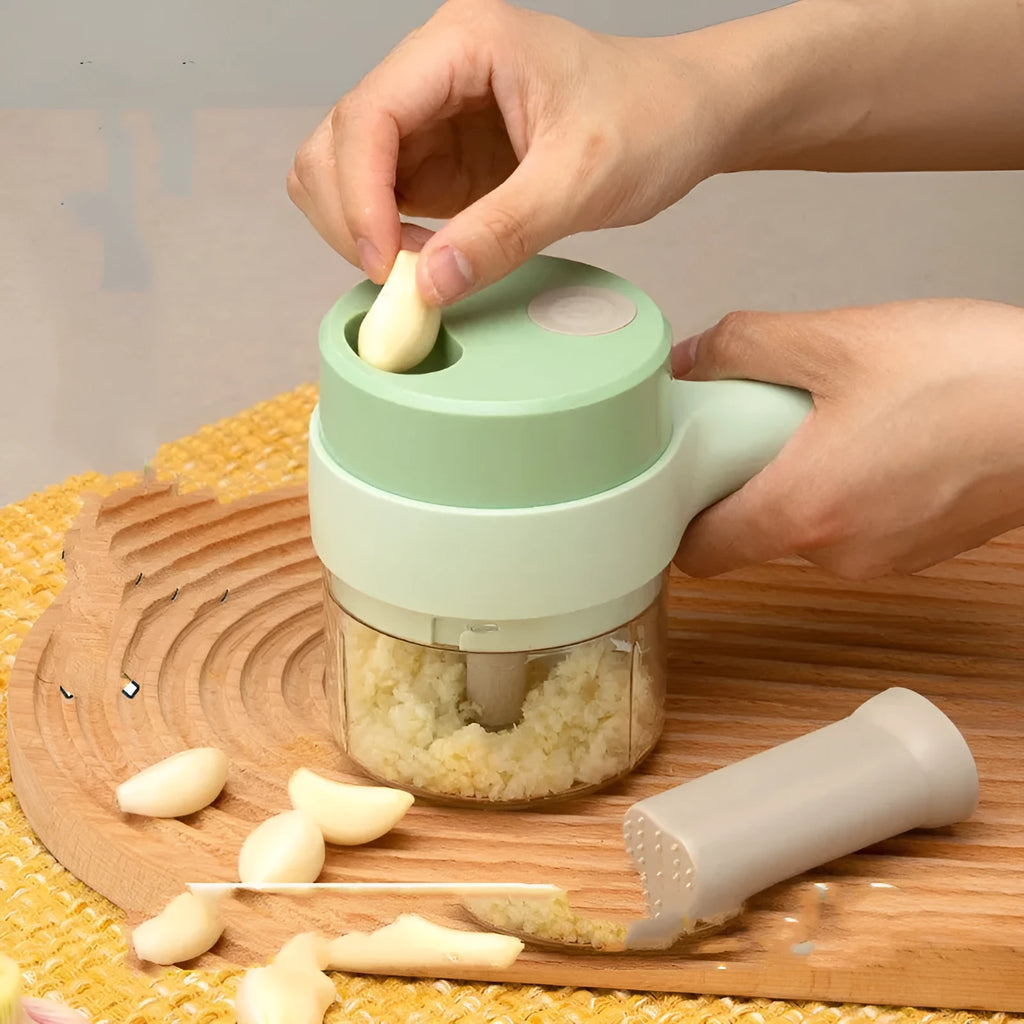 Household multifunctional wireless electric garlic masher with plastic body, slicer combo, and Type-C cable on white background