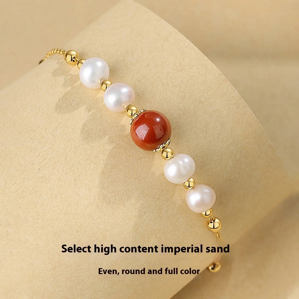 Yellow retro-style bracelet with red cinnabar beads and white pearls on a silver chain.