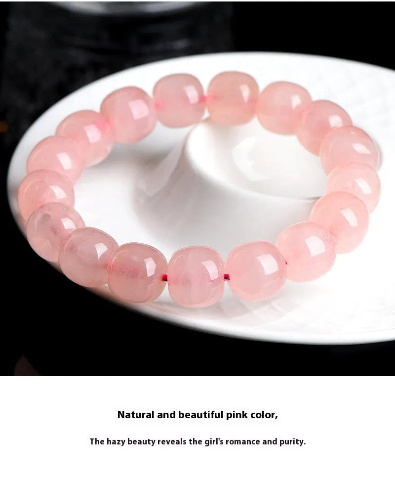 Natural pink crystal barrel bead bracelet with geometric design on wrist