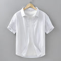 Men's loose-fitting short-sleeved cotton shirt in cardigan style shown in light grey colour