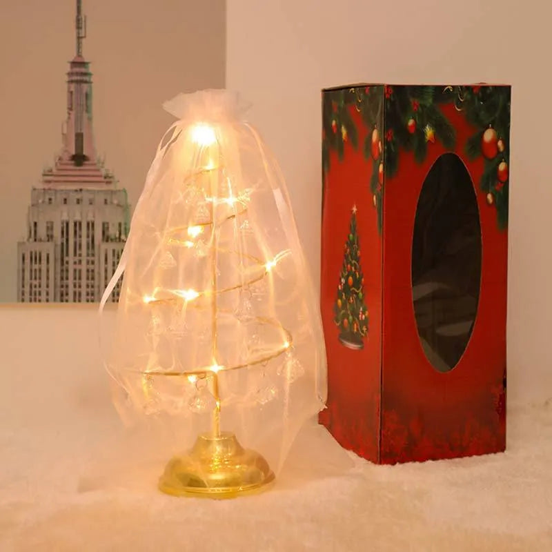 Gold crystal Christmas tree LED light with battery-powered warm glow on a shelf