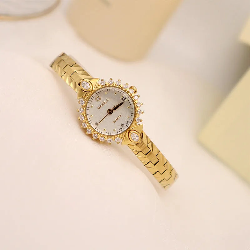 Women's vintage-style quartz watch with diamond-embossed dial and gold metal bracelet