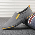 Men's low-top canvas casual shoe in grey with a vulcanised rubber sole and rounded toe.