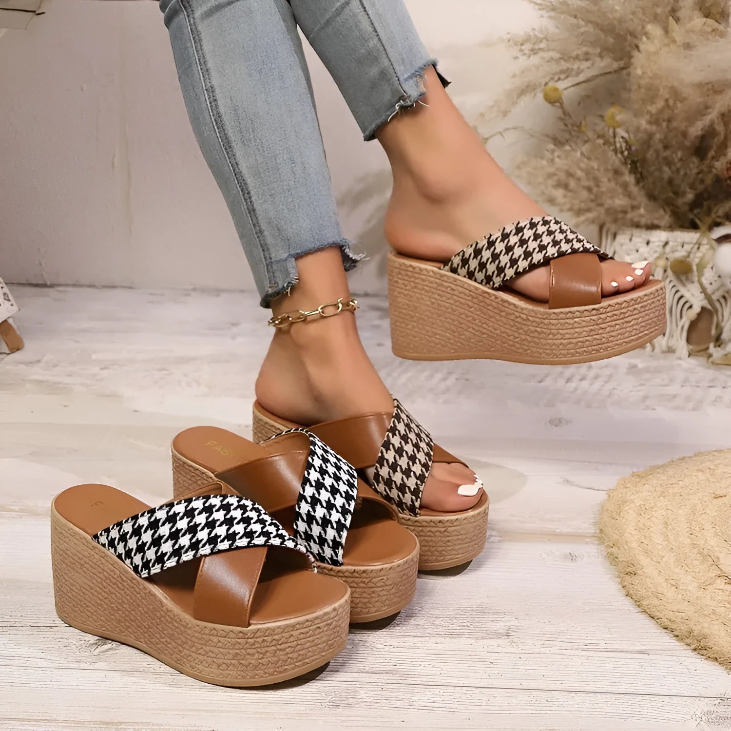 Brown and black plaid pattern wedge sandals with a rubber sole on a white background.