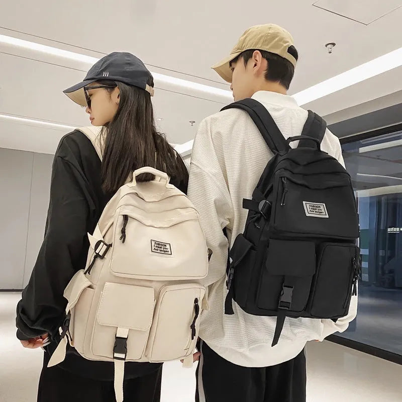 Black or white nylon student backpack with computer compartment measuring 31x12x41cm