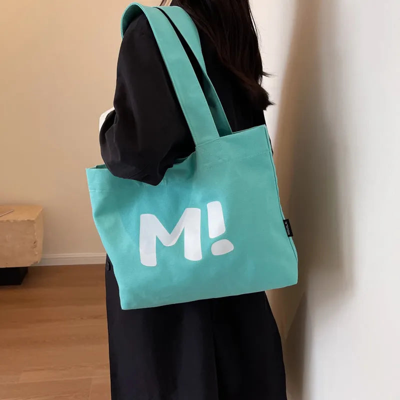 Letter print canvas shoulder bag in dark brown, large capacity tote with shoulder strap for women and girls.