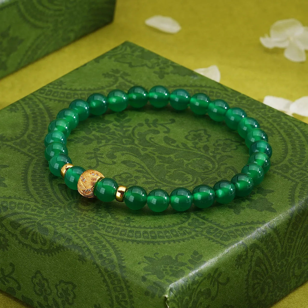 Green agate and sterling silver bracelet with geometric beads and yellow gold plating.