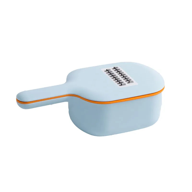 Dark blue manual vegetable cutter with four stainless steel blades, a hand protection guard, and a drain basket on a kitchen counter.