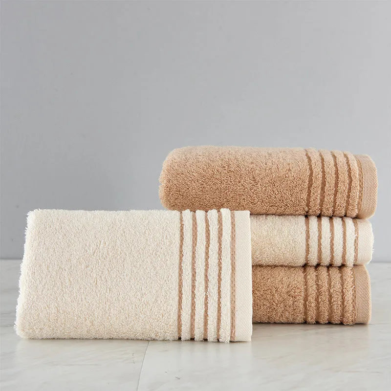 Cotton towel set in beige and brown showing face, hand, and bath towel sizes