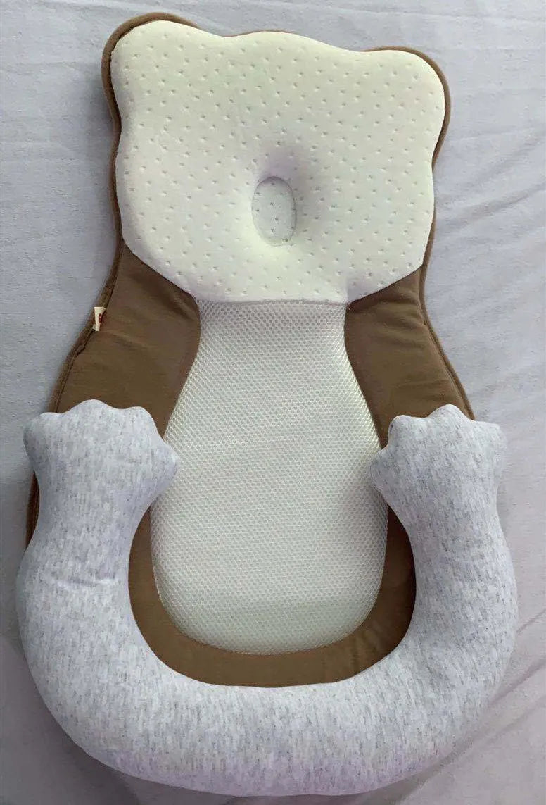 Folded portable baby travel bed with a soft beige cotton sleep cushion for newborns