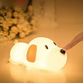 A two-tone cartoon dog-shaped silicone night lamp with a USB charging port.