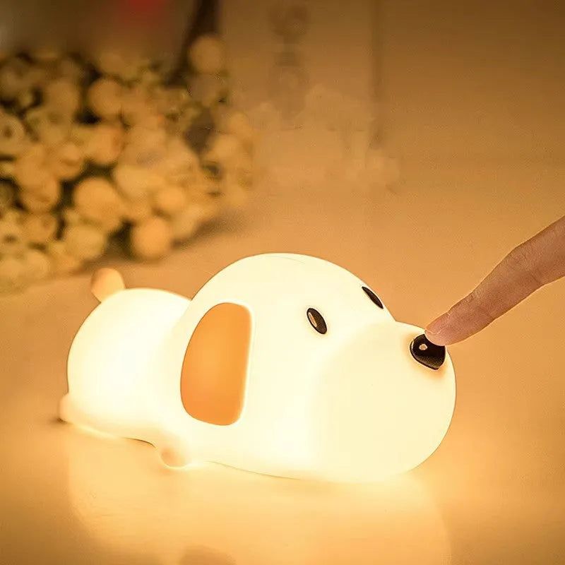 A two-tone cartoon dog-shaped silicone night lamp with a USB charging port.