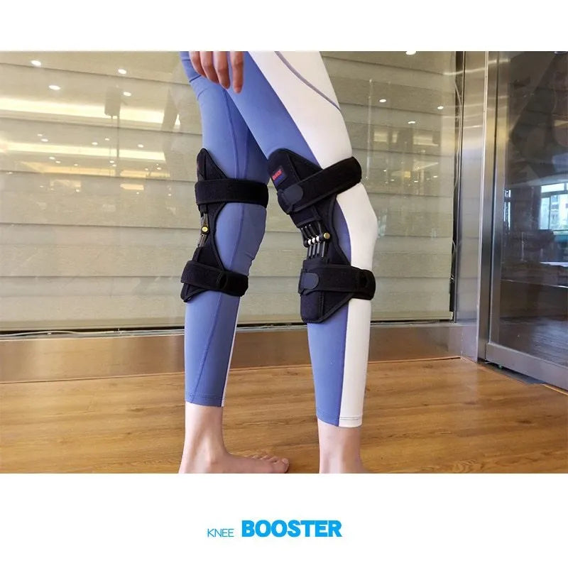 Black knee booster with carbon steel spring and Velcro straps on a neutral background