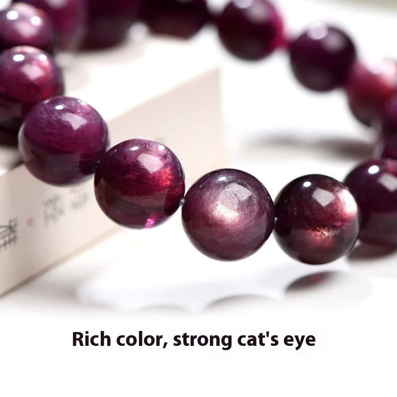 Natural purple lepidolite crystal round bead bracelet on a white background.