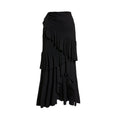 Women's black and white one-piece swimsuit with a detachable skirt laid flat on a beach towel.