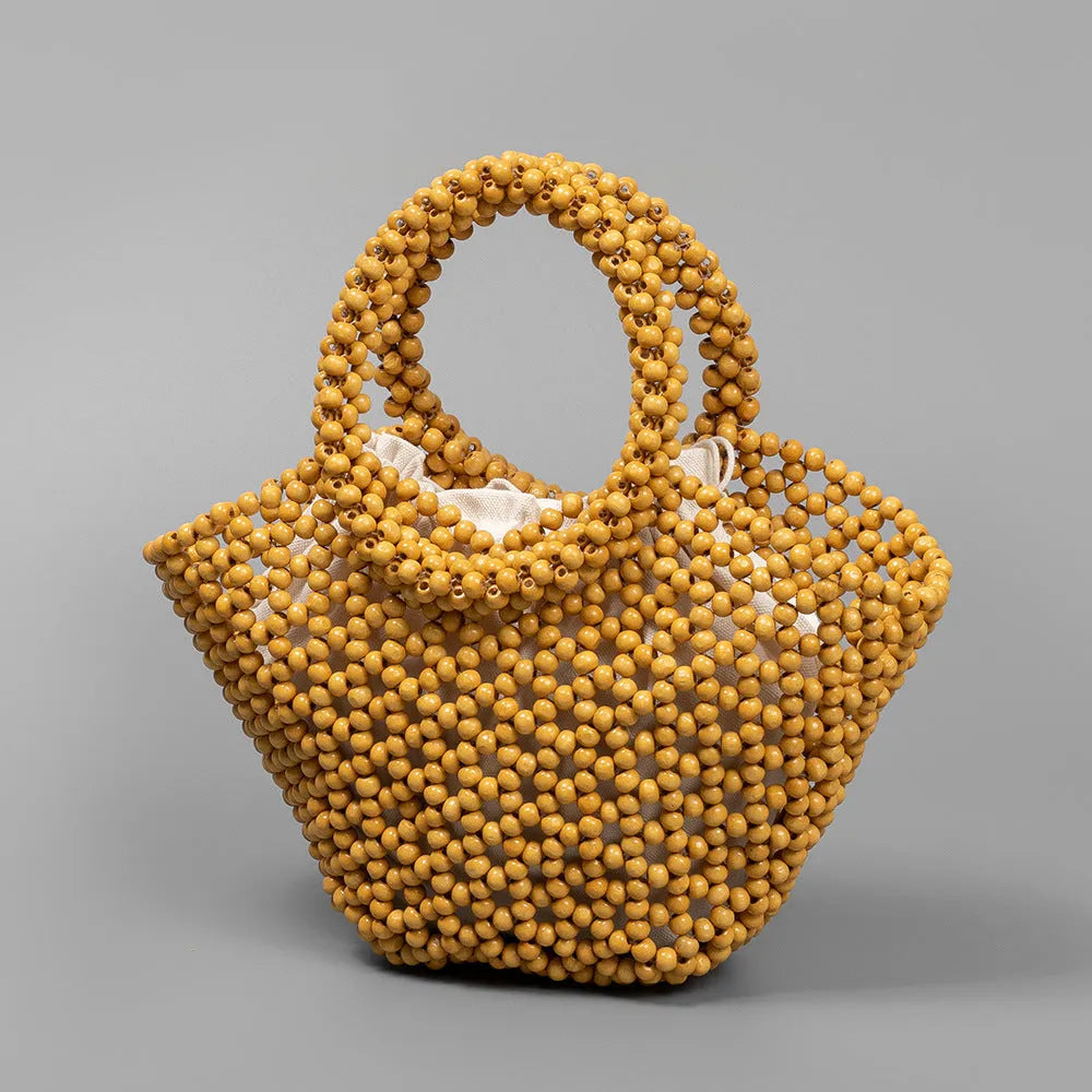 Hand-woven wooden bead beach handbag dumpling shape turmeric colour 13x7x18cm