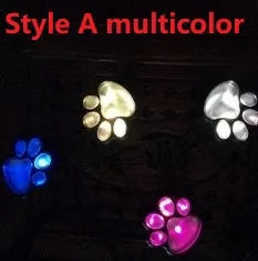 Black solar-powered bear paw-shaped garden light with ground stake and solar panel.
