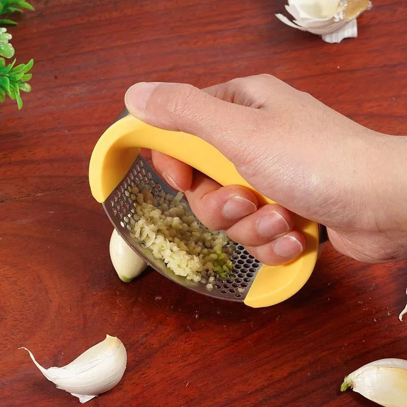 A stainless steel garlic press with a curved design and non-slip ergonomic handle.