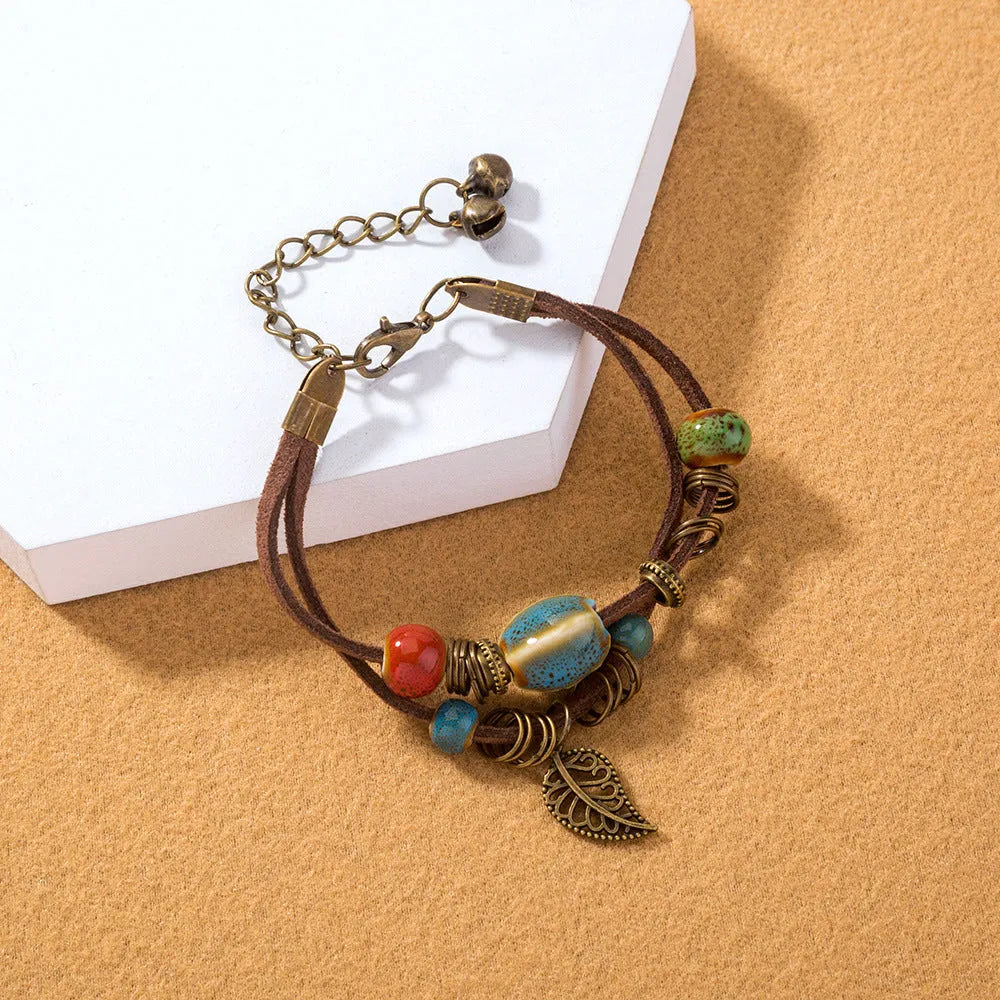 Hand-woven cowhide rope bracelet with ceramic beads in blue or white geometric bohemian style