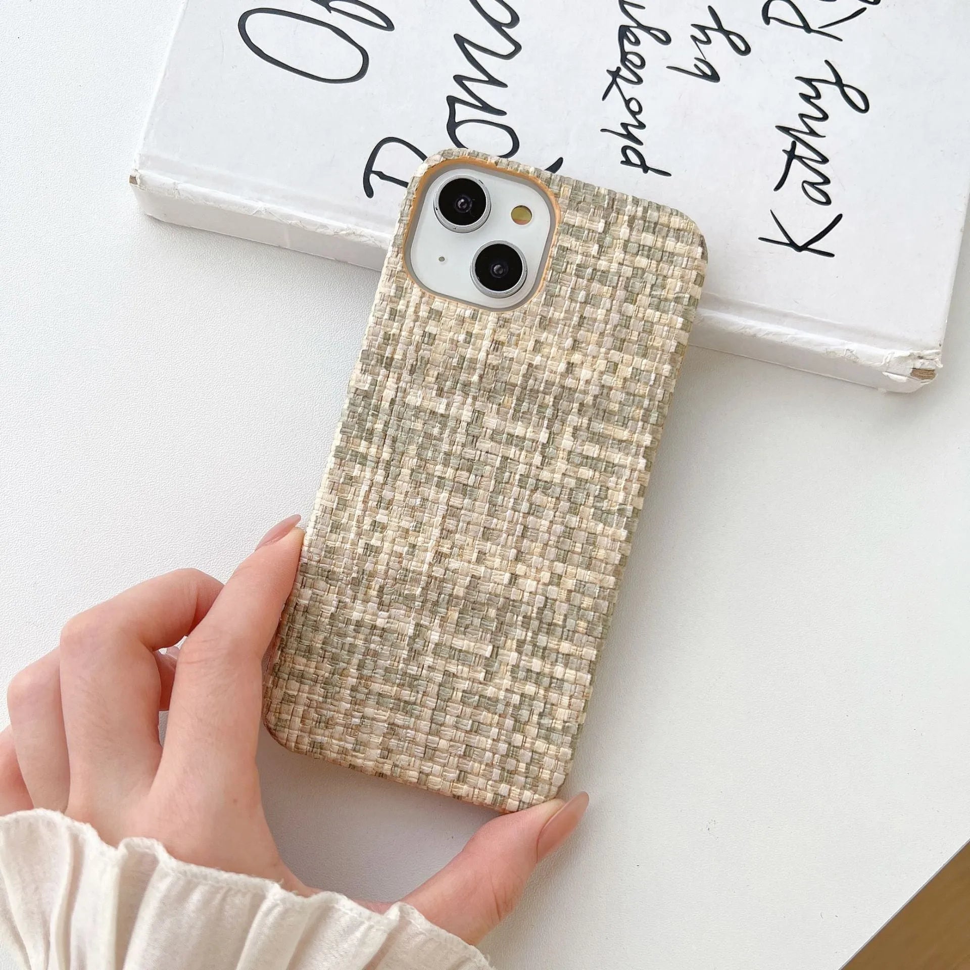 Hand-woven plaid TPU phone case in pink, shown on iPhone, with textured grip pattern and all-inclusive edges.