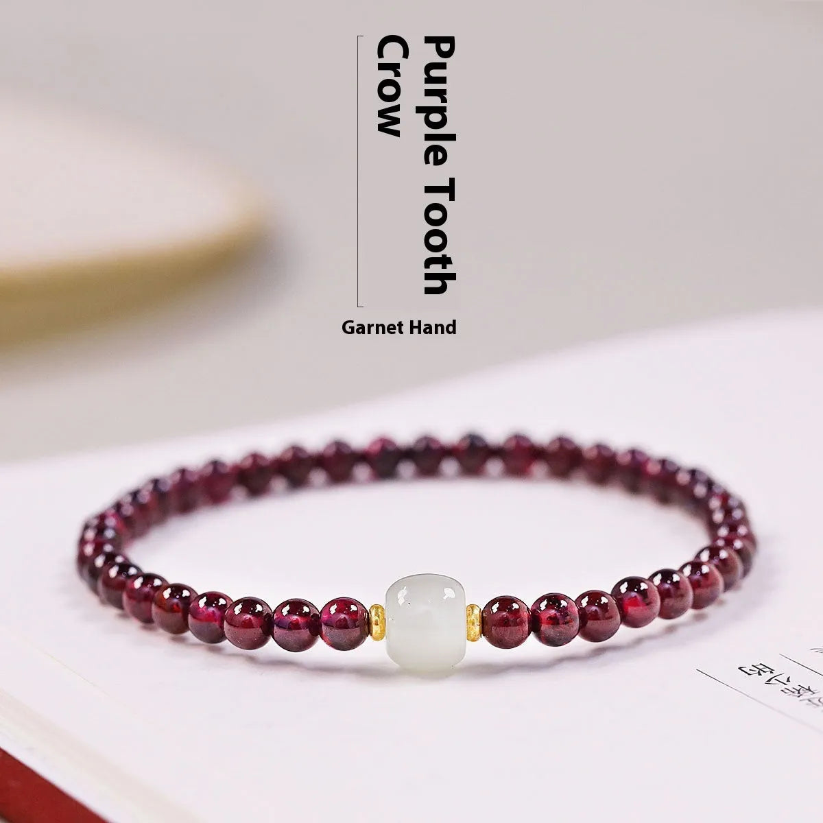 Natural garnet bracelet with U-shaped design showing garnet and dream garnet colour options