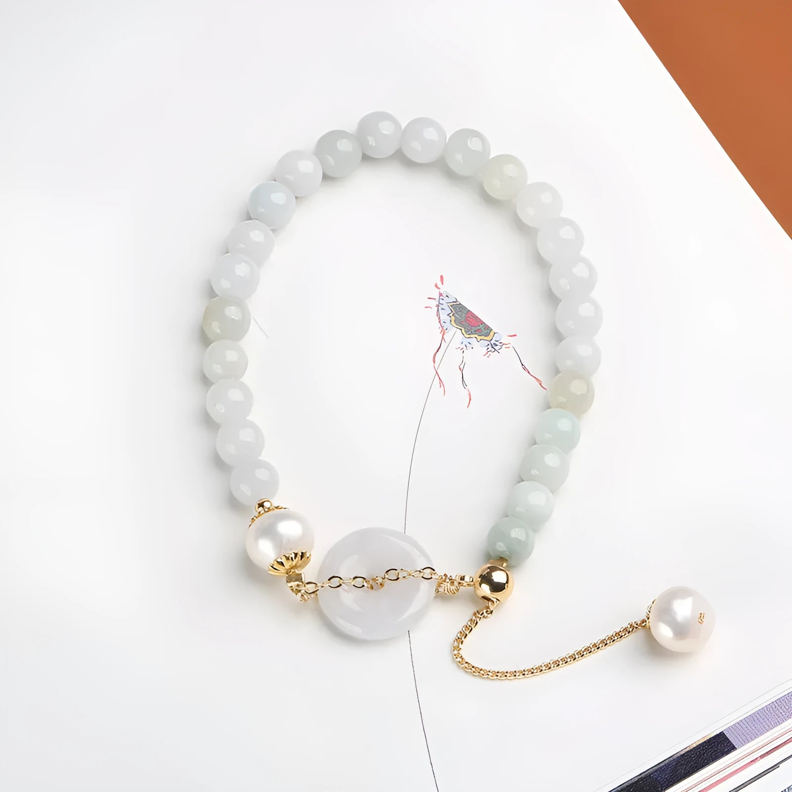 Jade bracelet with emerald peace buckle charm and pearl pendant in geometric national style design