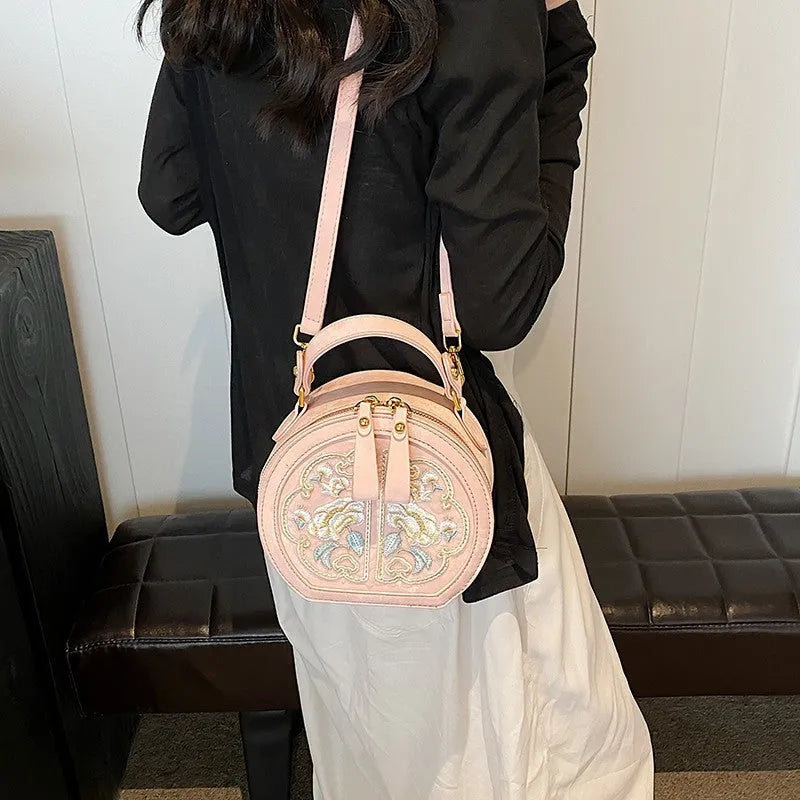 Soft PU Chinese embroidery messenger bag in horizontal square shape with adjustable shoulder strap.