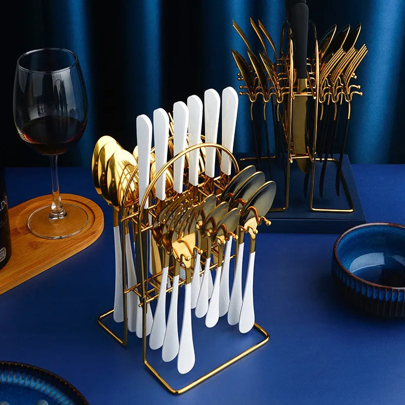 24-piece gold stainless steel cutlery set with knives, forks, spoons and a storage rack.