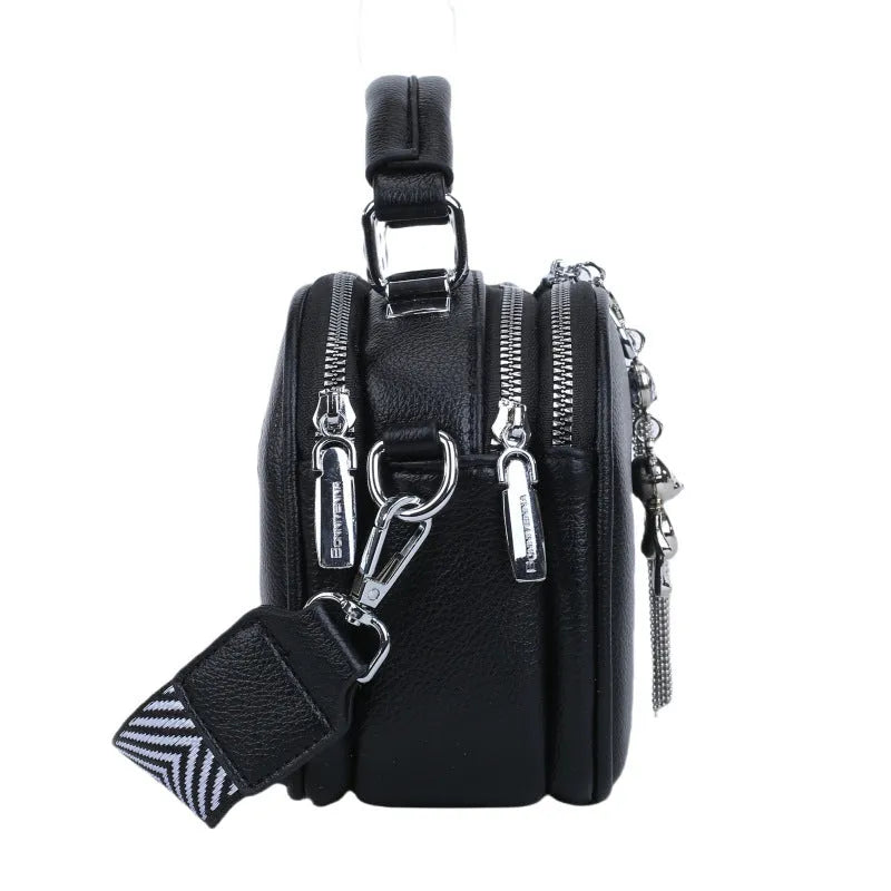 Women's small square stitching bag in oval shape with double shoulder strap showing internal mobile phone compartment.
