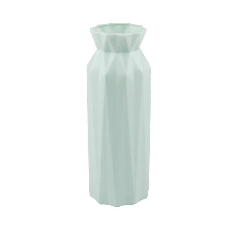 Simple green melamine plastic vase with a 7.2cm base diameter on a wooden table.