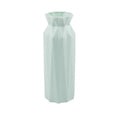 Simple green melamine plastic vase with a 7.2cm base diameter on a wooden table.