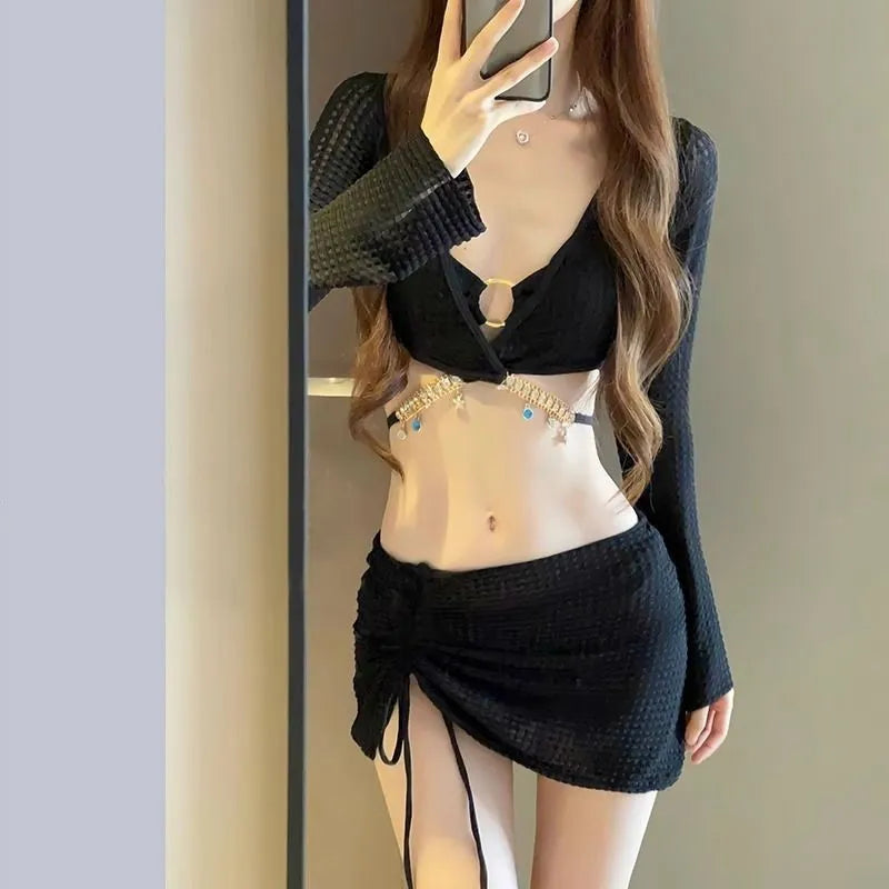 Women's black long sleeve bikini swimsuit with split hot spring design on white background