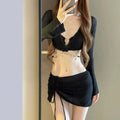 Women's black long sleeve bikini swimsuit with split hot spring design on white background