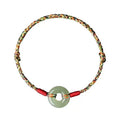Colourful woven rope bracelet with silver peace buckle clasp on wrist