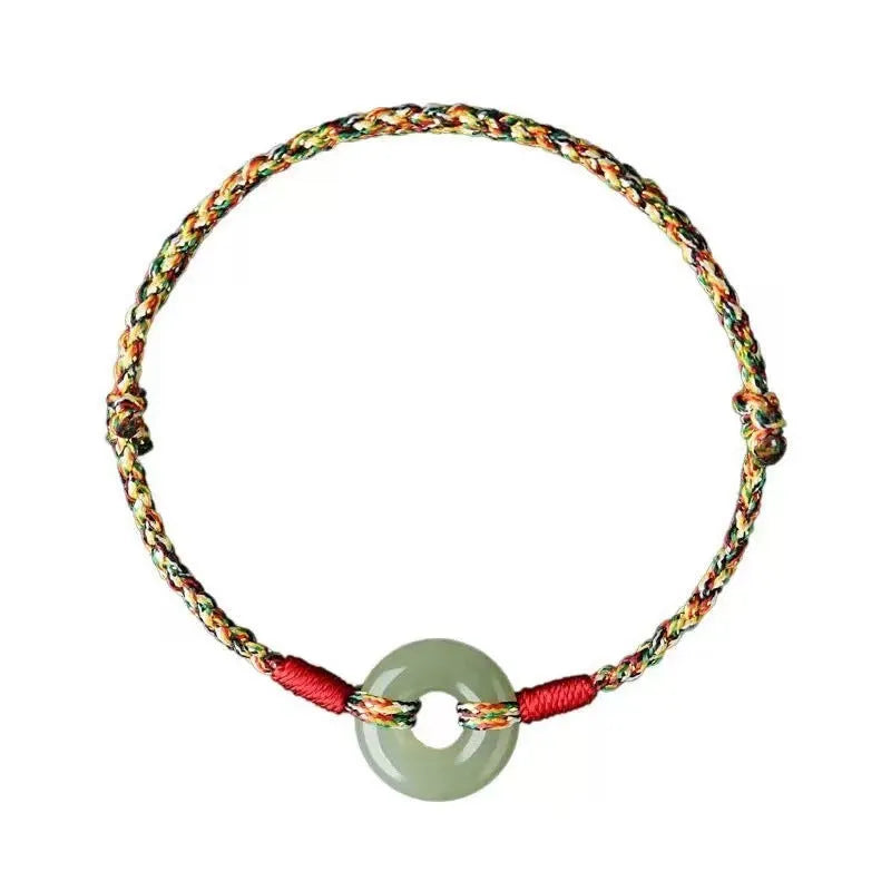 Colourful woven rope bracelet with silver peace buckle clasp on wrist