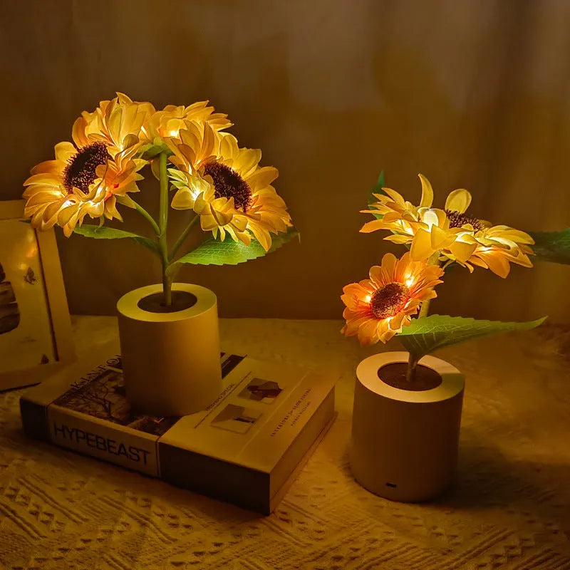 Rechargeable artificial sunflower LED night light on a table with USB charging cable.