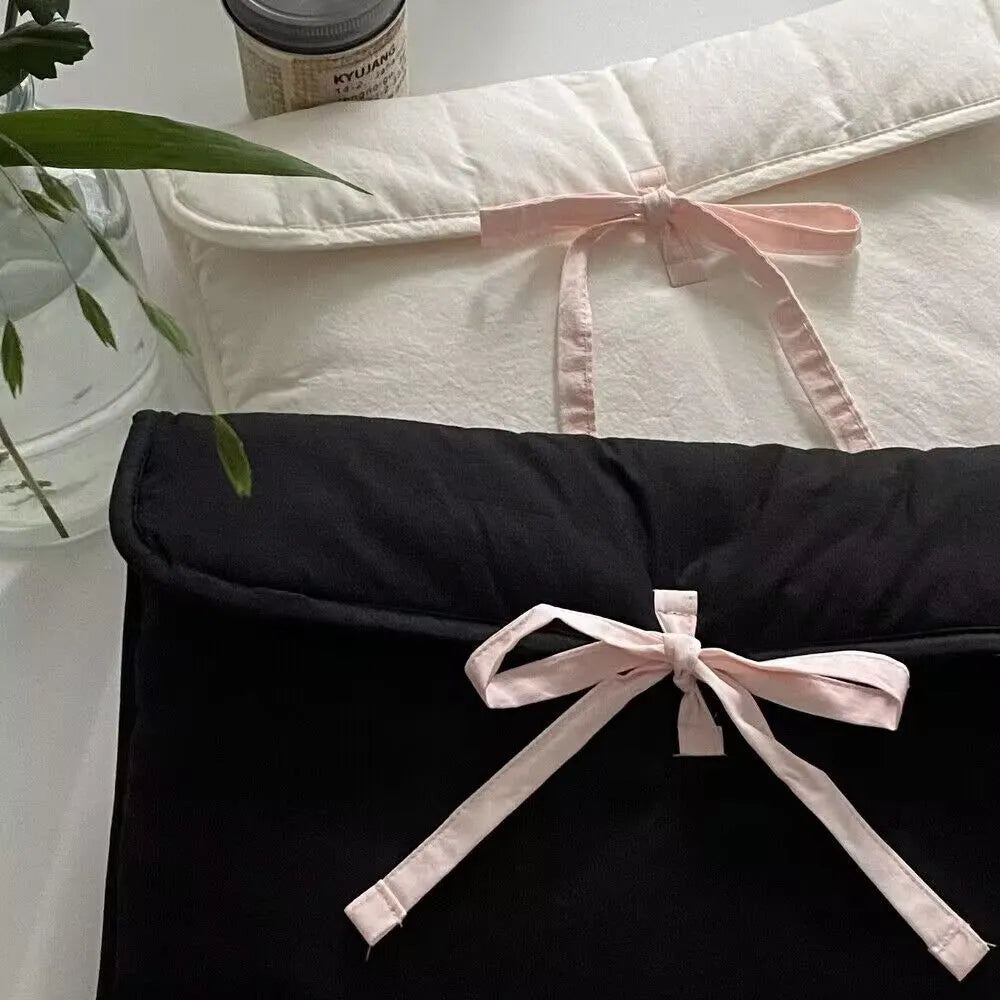 Women's black quilted laptop bag with ballet bow and striped pattern design