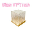 Square crystal LED table lamp projecting blue water ripple light patterns on a wall.