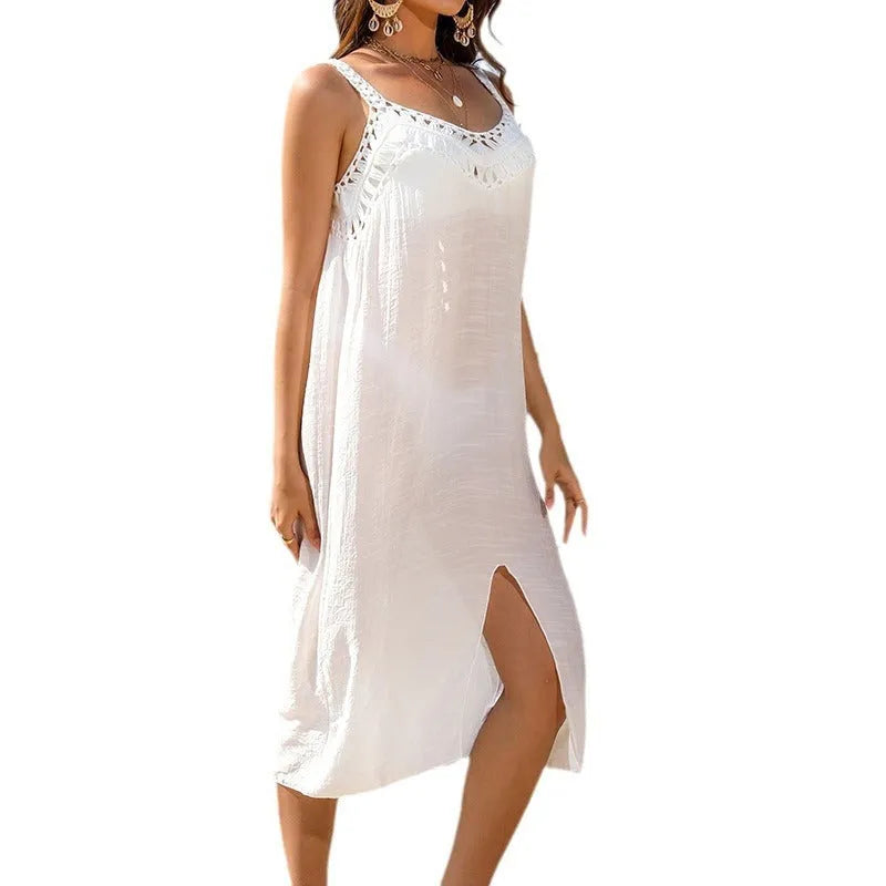 White women's crochet beach dress with adjustable straps and a side slit.