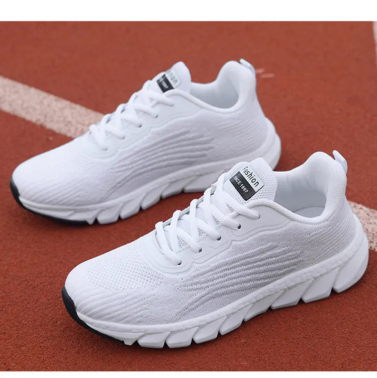 Low-top black and white running sneakers with cross strap design and MD sole