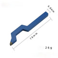 Close-up of a curved character steel stamping tool for jewellery on a workbench.