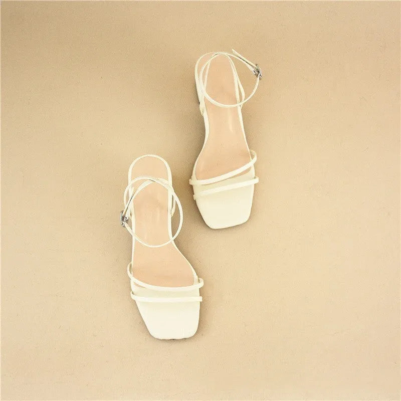 Beige women's sandals with a chunky stiletto heel, square toe, and adjustable ankle buckle on a white background.
