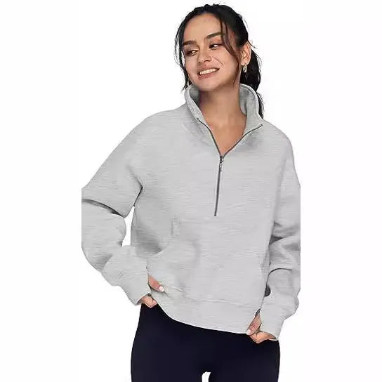 Woman wearing a loose lapel fleece-lined sweater in a solid colour, showing raglan sleeve detail.