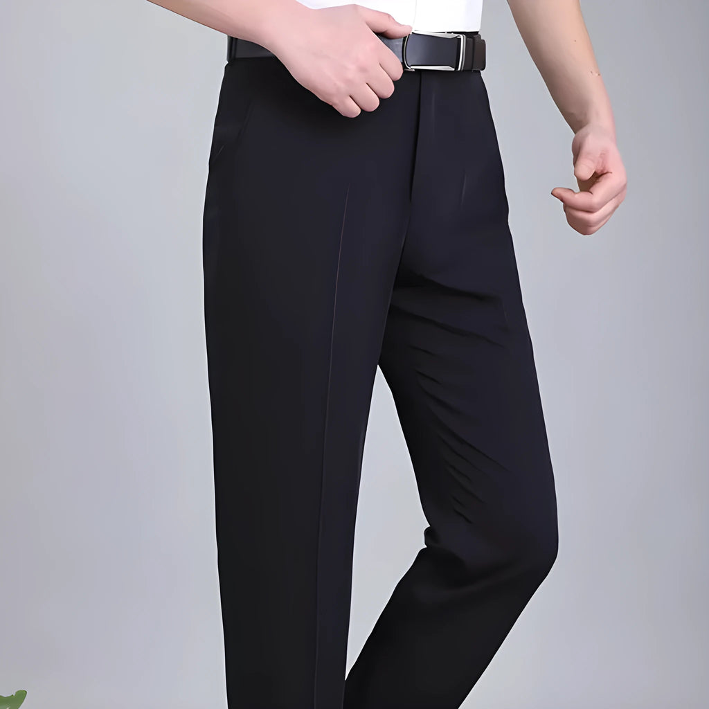 Man wearing dark blue straight-cut high-waist business trousers made from a mulberry silk blend.