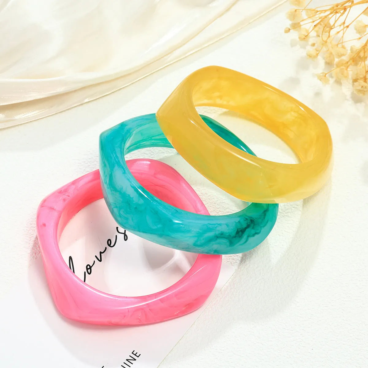Resin arc bracelet in coffee colour with geometric blooming design and electroplating finish